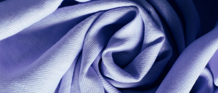 Color of the year 2022. Very Peri. Crumpled fabric background. Abstract background.